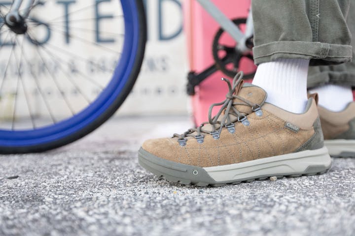 Closeup of the Oboz Beall Low casual shoe, in front of a bike.