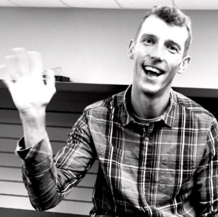 Mike Newlands at the Oboz office waving at the camera.