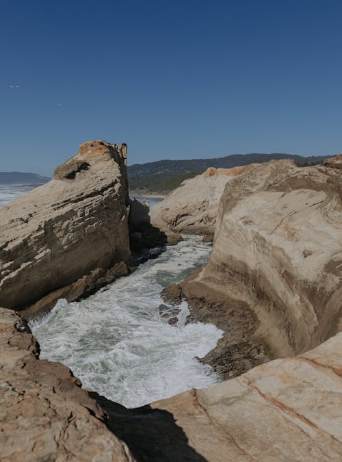 Ocean water flowing into rock formation off the Oregon Coast