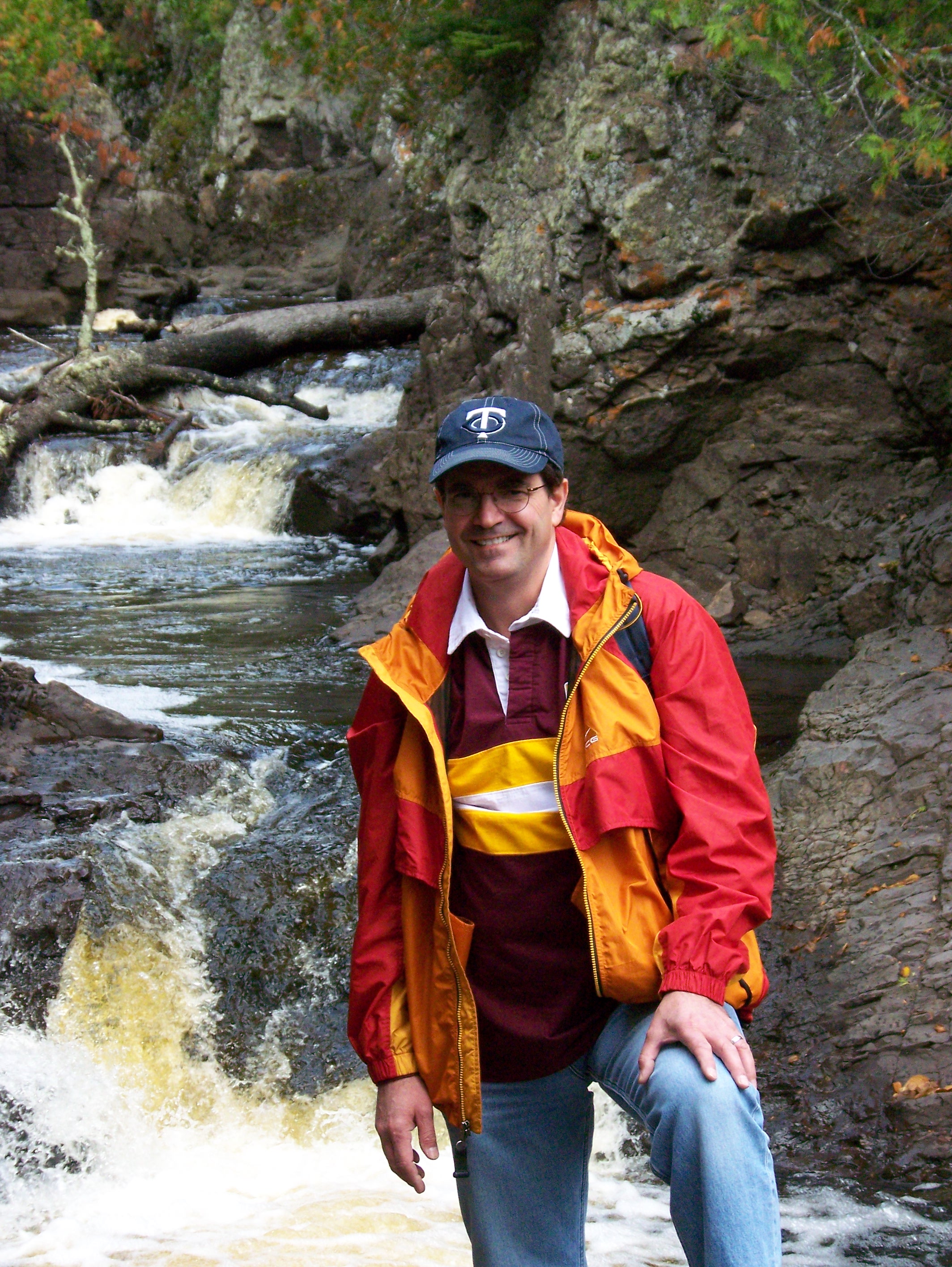 Oboz Footwear Trailblazer Joel Meline smiling near a waterfall.