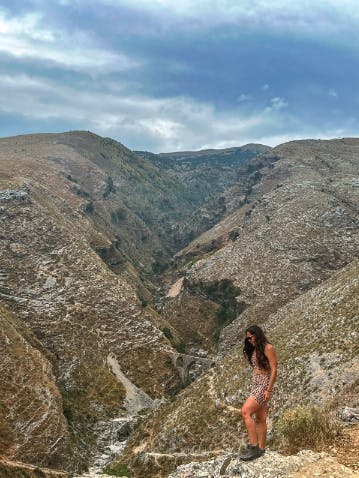 Woman hiking on the top of a mountain in the Sawtooth X Mid hiking boots