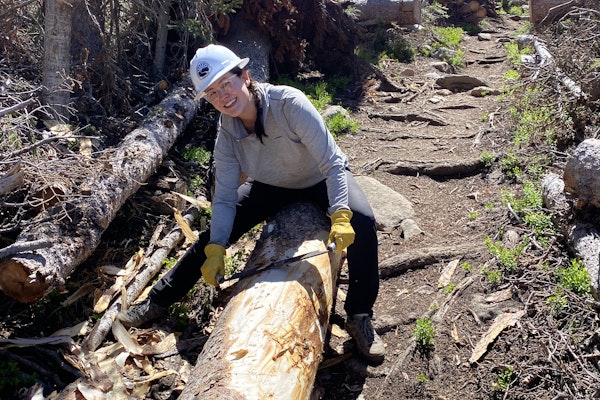 Woman doing trail maintenance in Oboz Sawtooth X Low hiking shoes. 
