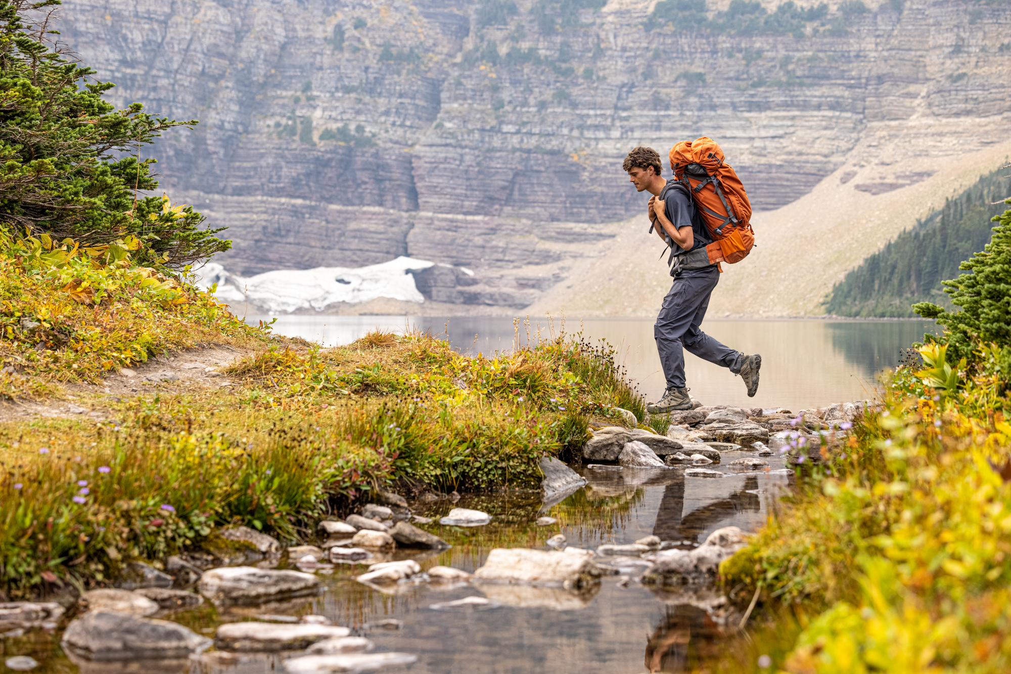 Man backpacking in the Montana backcountry wearing Oboz Sawtooth X Mid hiking boots.