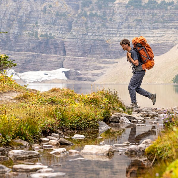 Man backpacking in the Montana backcountry wearing Oboz Sawtooth X Mid hiking boots.