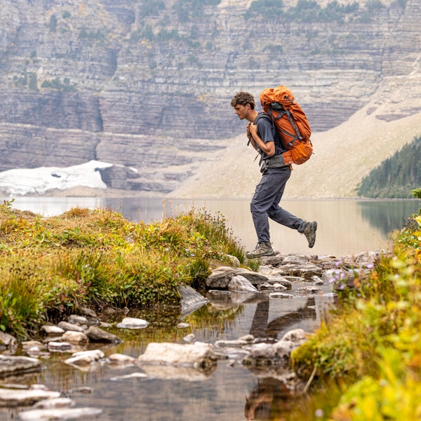 Backpacker hiking in the Montana backcountry with a loaded backpack.