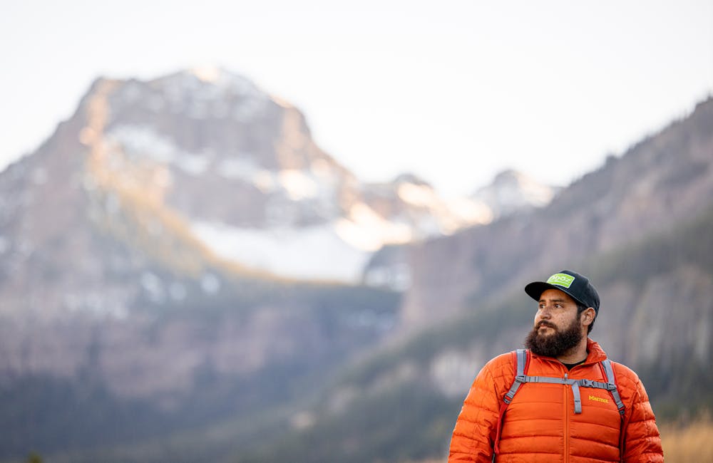 Hiker wearing an Oboz Footwear baseball cap.
