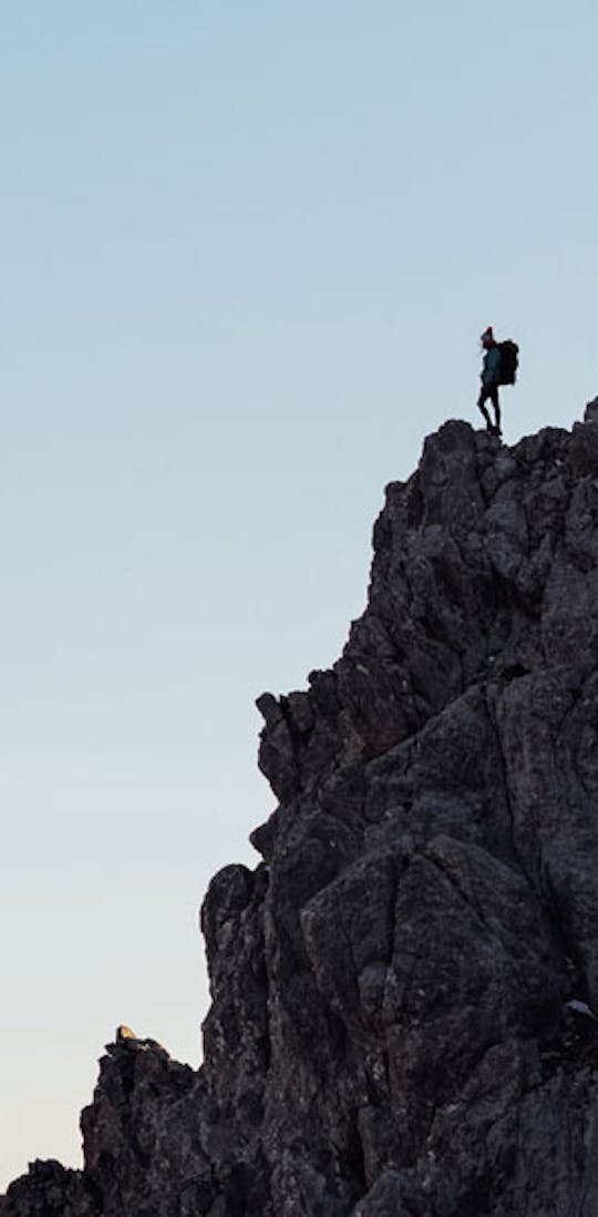 Hiker enjoying the view from a rocky outcrop.