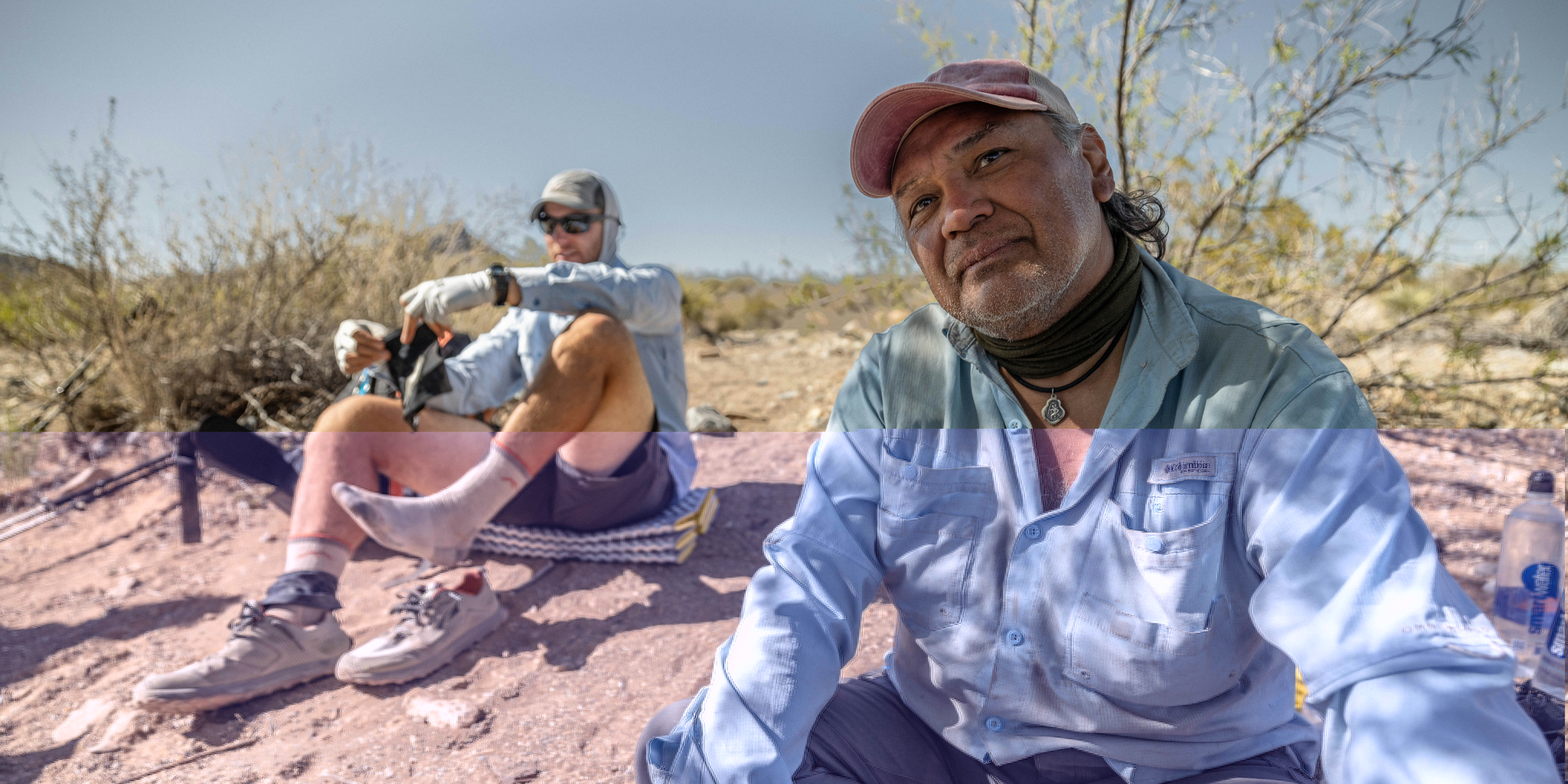 Two hikers taking a rest in the desert while hiking on the Continental Divide Trail.