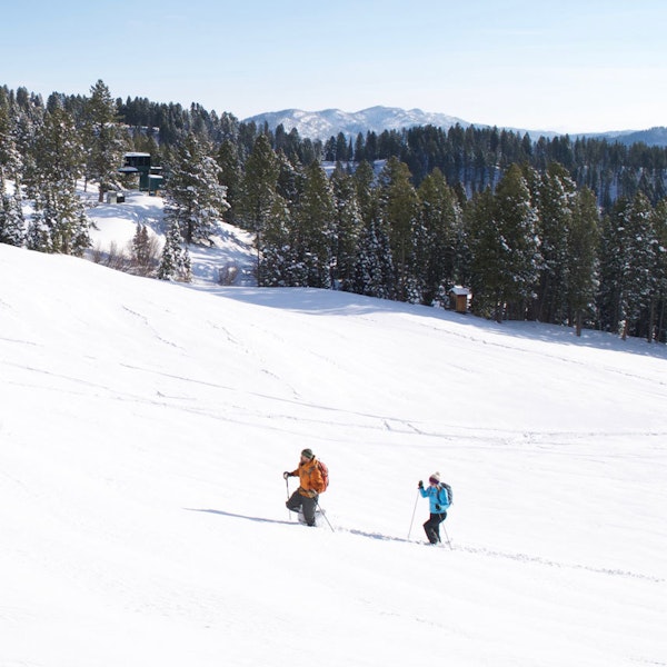 Two people snowshoeing in Oboz Bridger Insulated Waterproof winter boots.