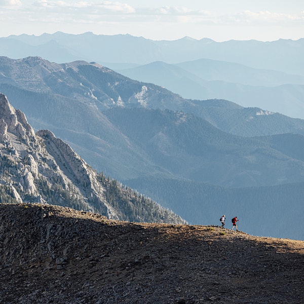 Two people in Oboz footwear hiking technical ridge terrain near Bozeman, MT.