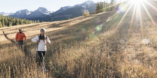 Two hiking partners enjoying an adventure in the mountains wearing Oboz hiking boots.