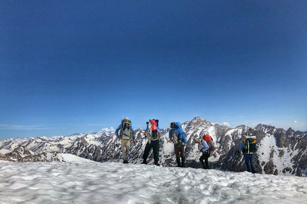 Backpacking on a snow covered trail in winter