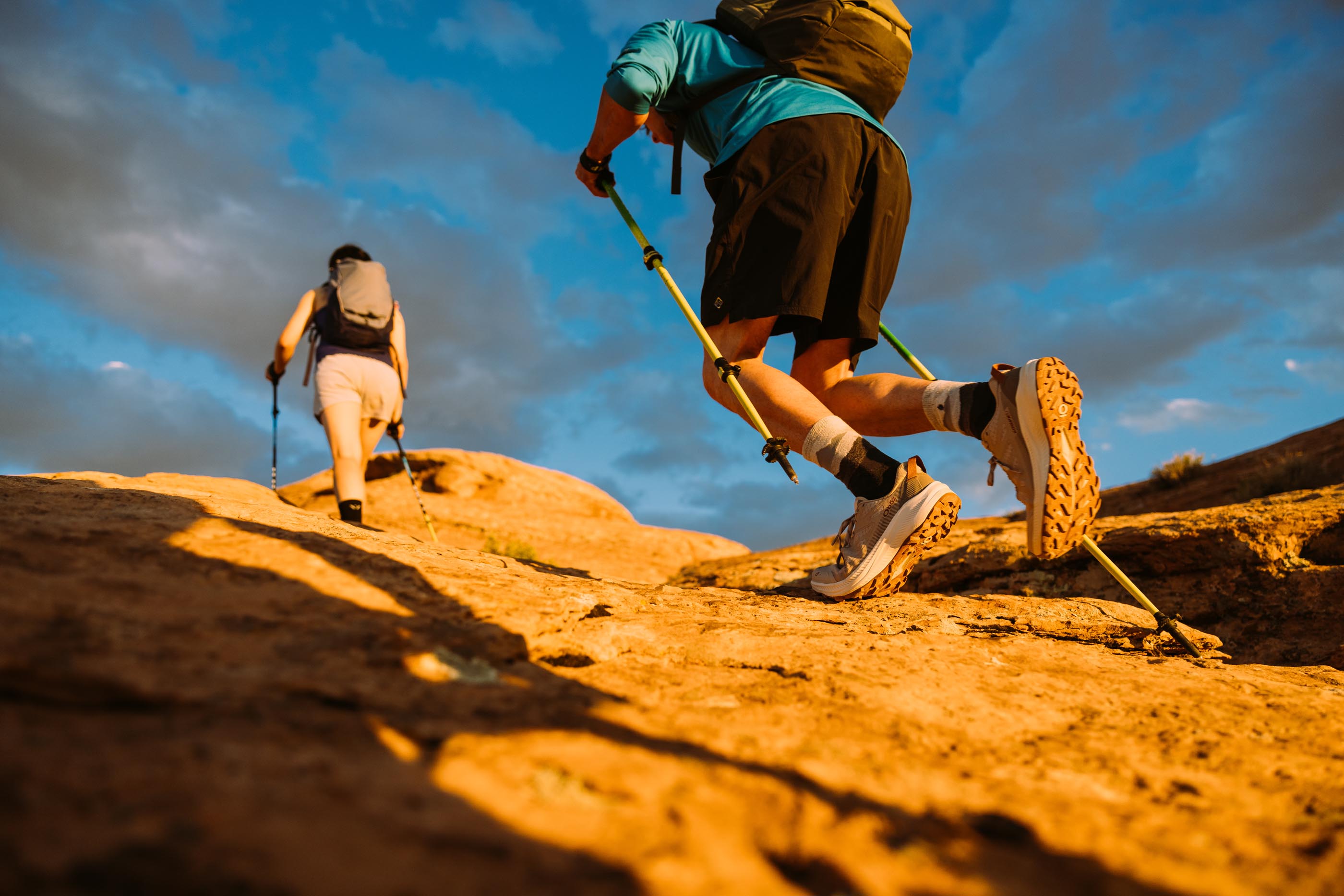 Two hikers moving quickly in the Oboz Katabatic LT Low hiking shoes.