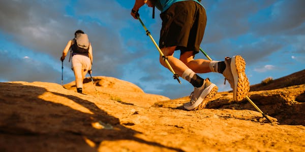 Two hikers moving quickly in the Oboz Katabatic LT Low hiking shoes.