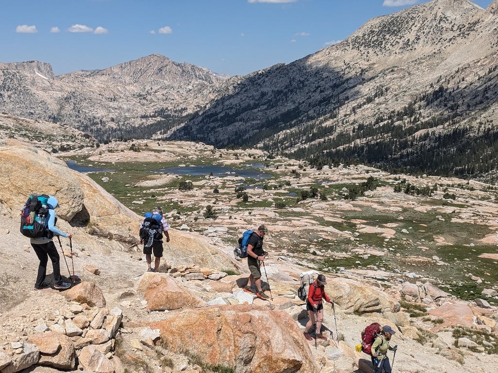 Hikers on the PCT traverse rocky terrain in Oboz hiking shoes