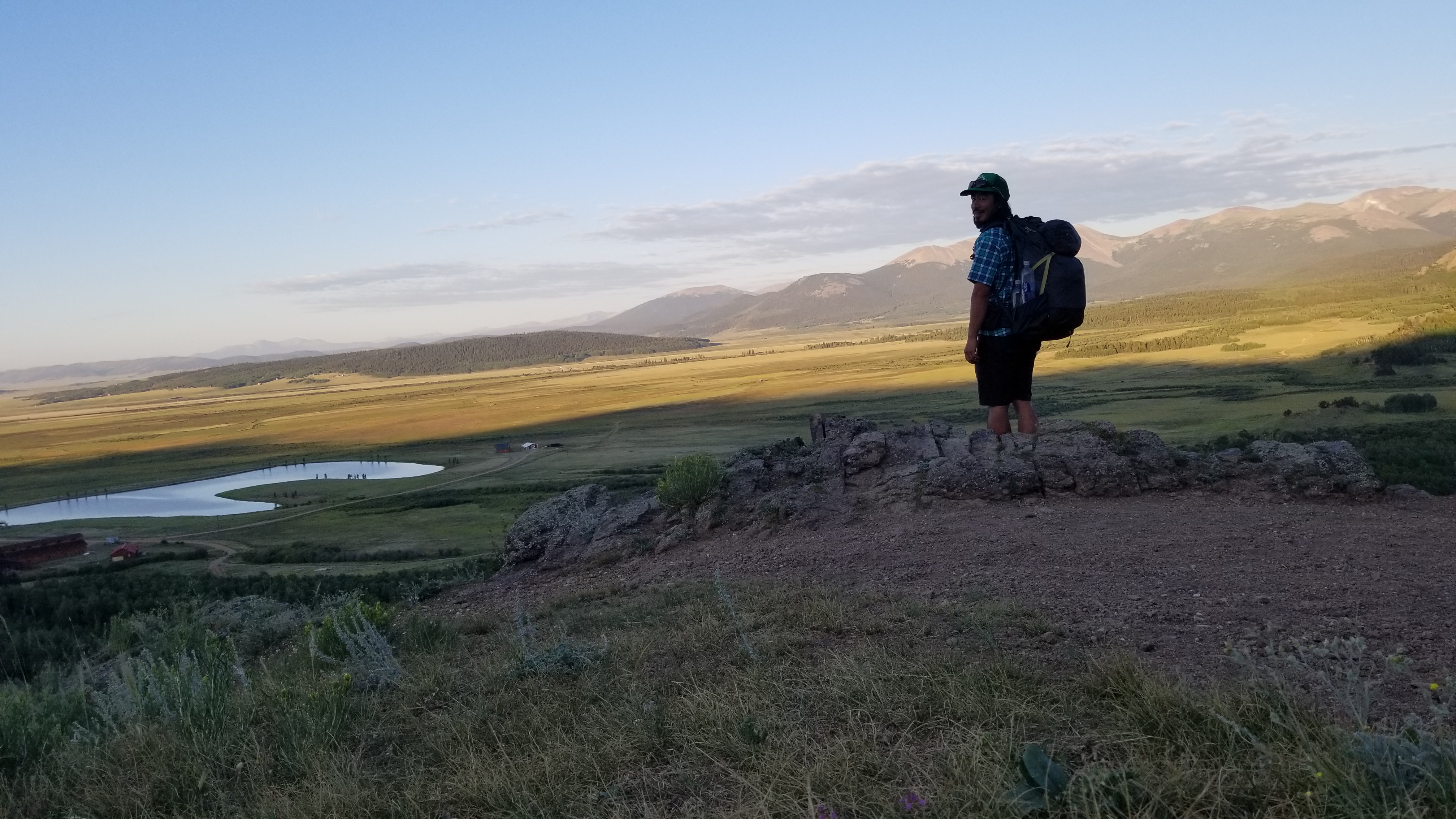 Tyler stands at an overlook during a backpacking adventure. 
