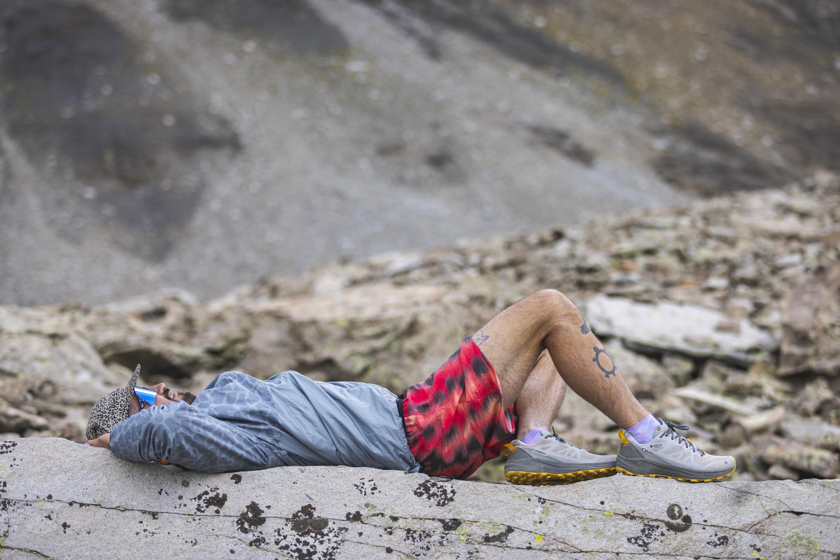 Relaxing during a hike while wearing Oboz Katabatic LT Gore-Tex hiking shoes.