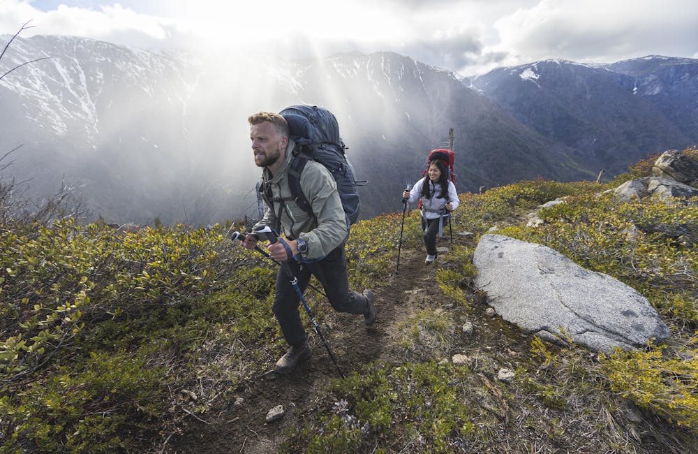 Two hikers wearing Oboz Bridger Peak Gore-Tex hiking boots on a rocky trail.