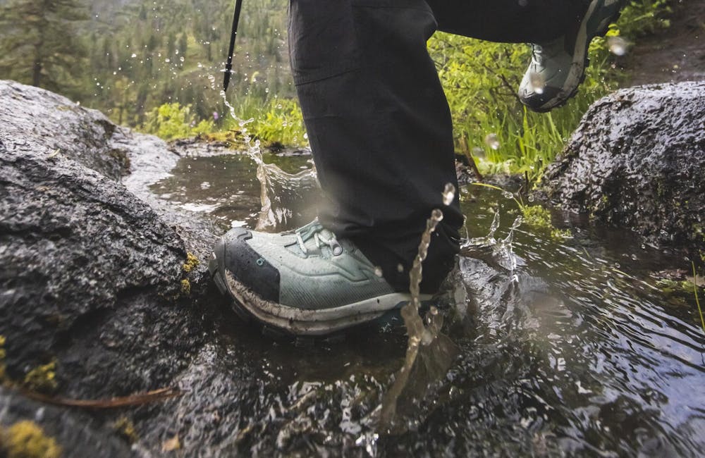 Wearing Oboz women's Bridger Peak Gore-Tex hiking boots through a creek crossing.