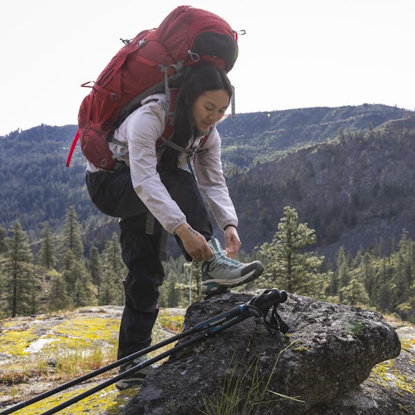 Lacing the Oboz women's Bridger Peak Gore-Tex hiking boots.