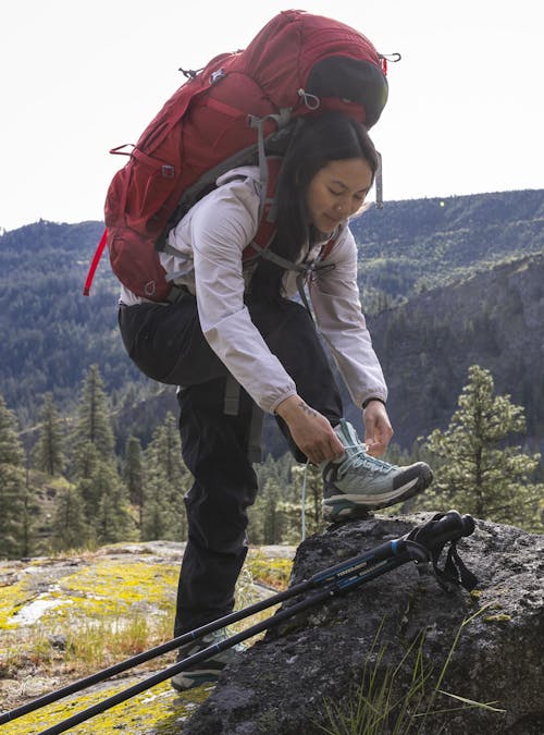 Lacing the Oboz women's Bridger Peak Gore-Tex hiking boots.