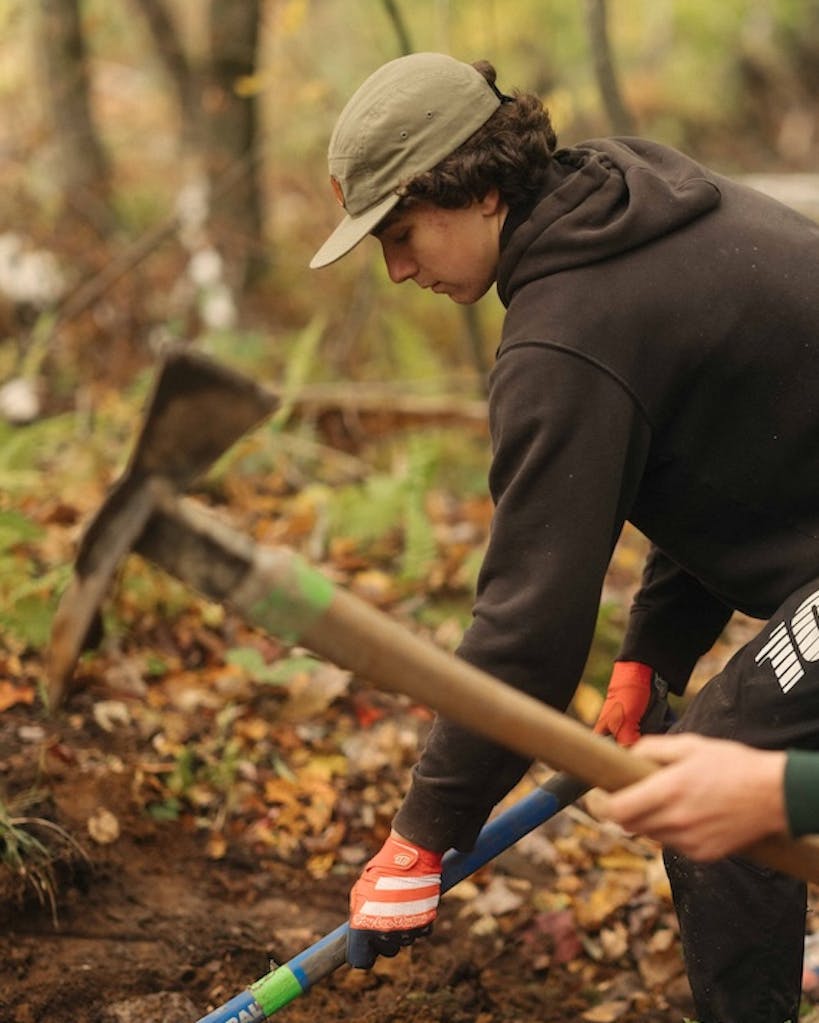 Two young trial builders help to repair trail systems.