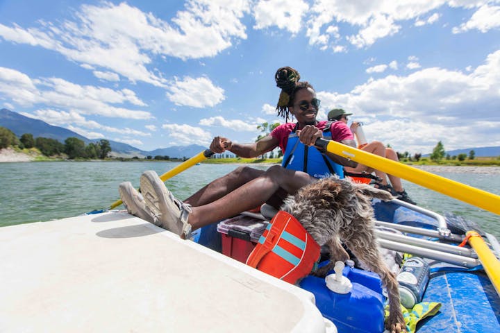 Group of people rafting down Yellowstone river while wearing Oboz sandals