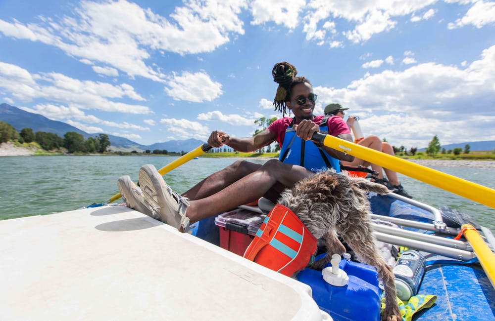 Group of people rafting down Yellowstone river while wearing Oboz Whakata sandals.