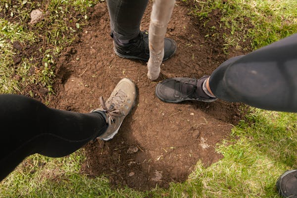 Oboz during a tree planting wearing Oboz hiking shoes.