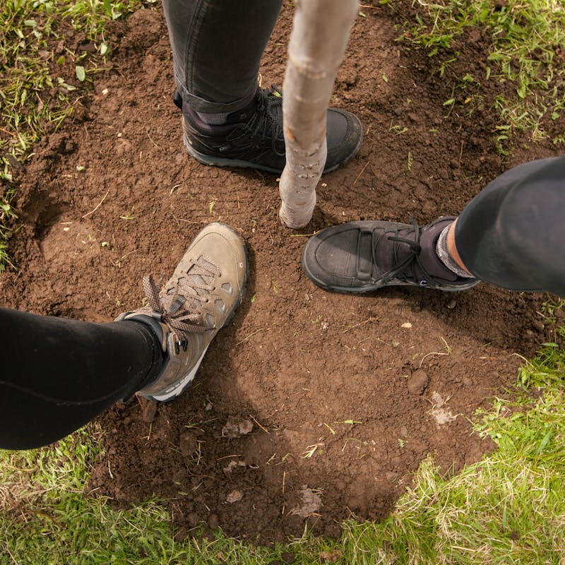 Oboz during a tree planting wearing Oboz hiking shoes.