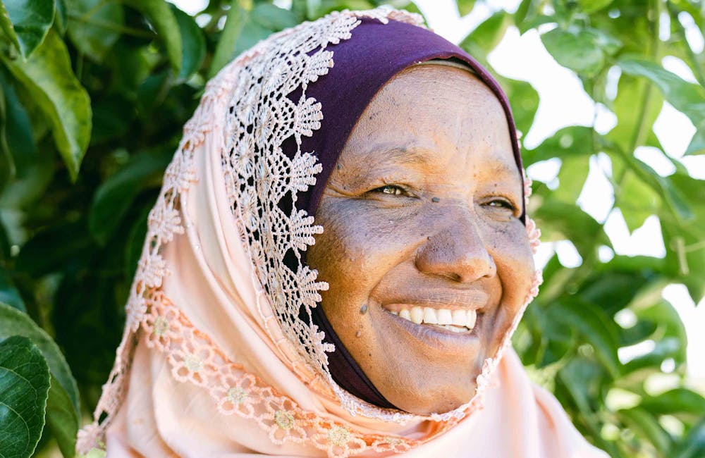 Woman smiling in a One More Tree farming facility.