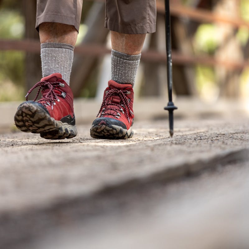 Oboz Local Hero Jo Giese on a hike at Ousel Falls, in Big Sky, Montana wearing the Rio Red Bridger Mid hiking boots.