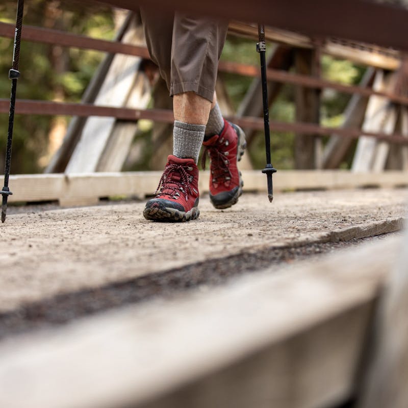 Oboz Local Hero Jo Giese on a hike at Ousel Falls, in Big Sky, Montana wearing the Rio Red Bridger Mid hiking boots.