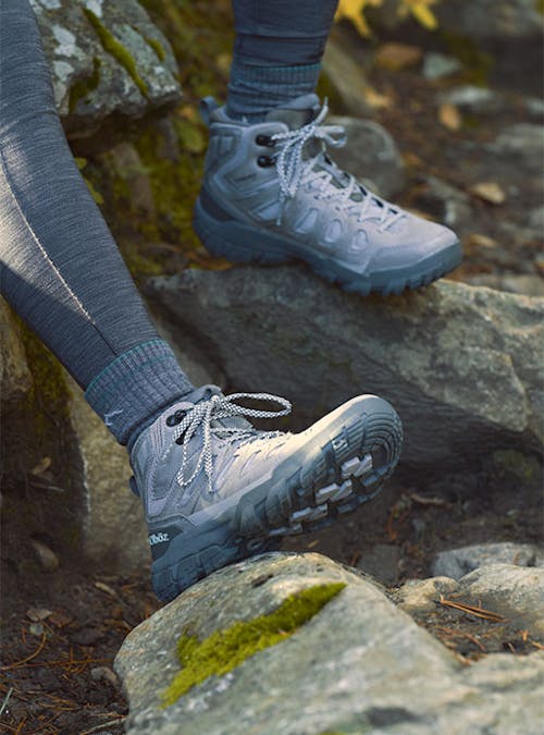 Oboz Sawtooth X hiking boots on rocky terrain.