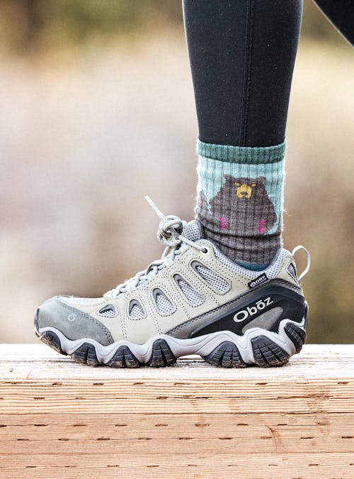Woman walking on a wooden bridge in Oboz Sawtooth II boots