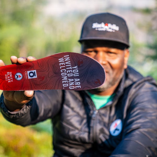 Earl Hunter holding an Oboz x BFCT Unity Blaze Trail insole.