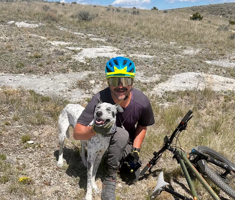 Oboz employee and his pup mountain biking at Copper City trails.