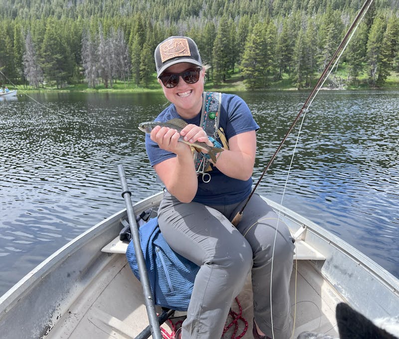 Oboz Footwear employee fishing on a lake in a drift boat.