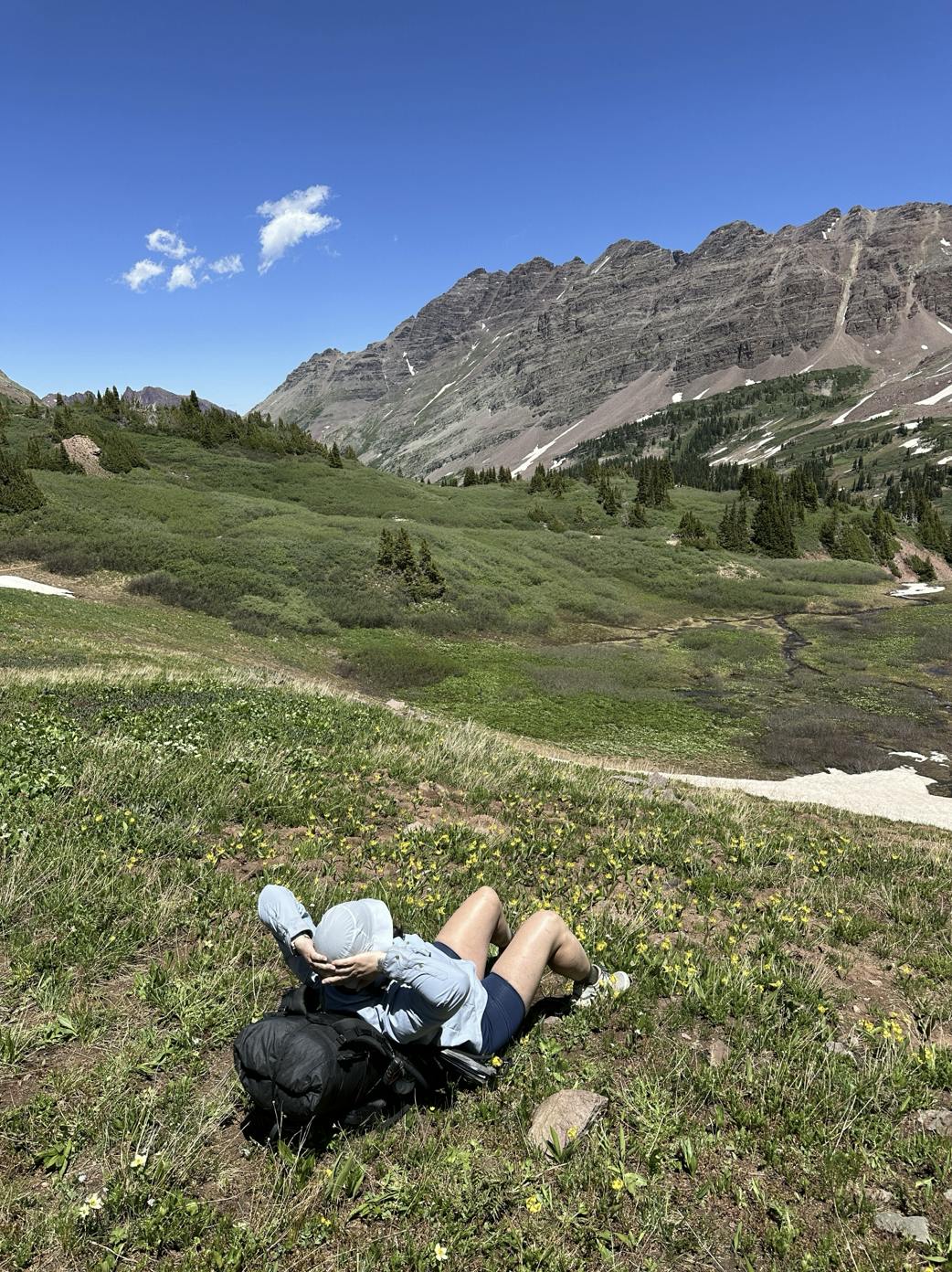 Kylie relaxing in a mountain meadow after a long day on the trail. 