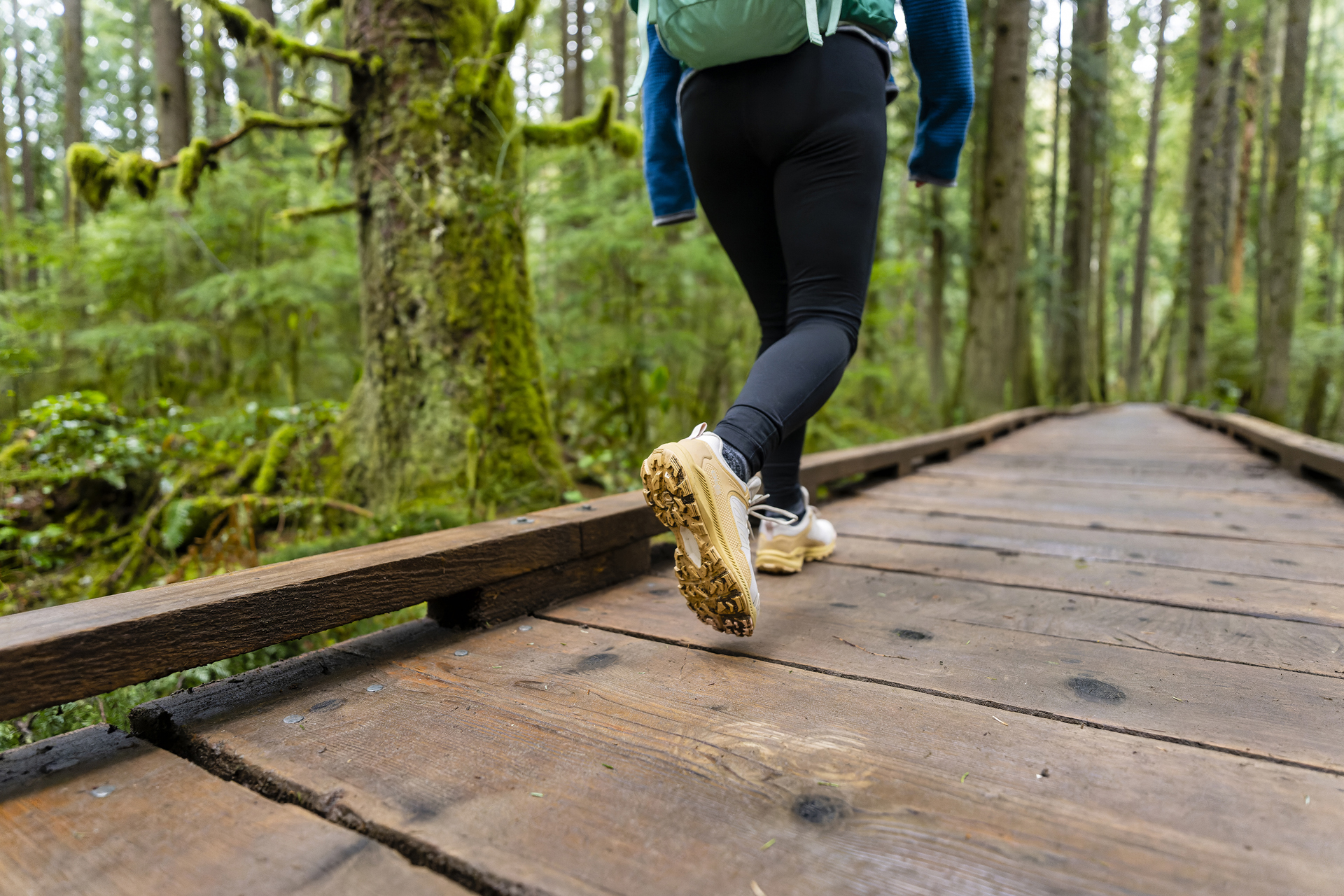 Woman walking through a forest in Oboz Katabatic low hiking shoes.