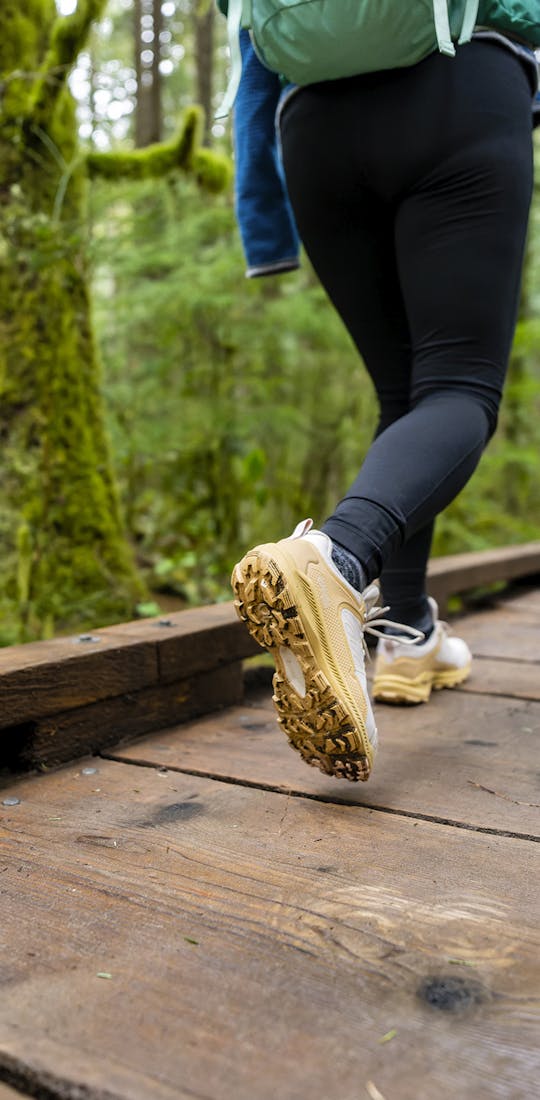 Woman walking through a forest in Oboz Katabatic low hiking shoes.