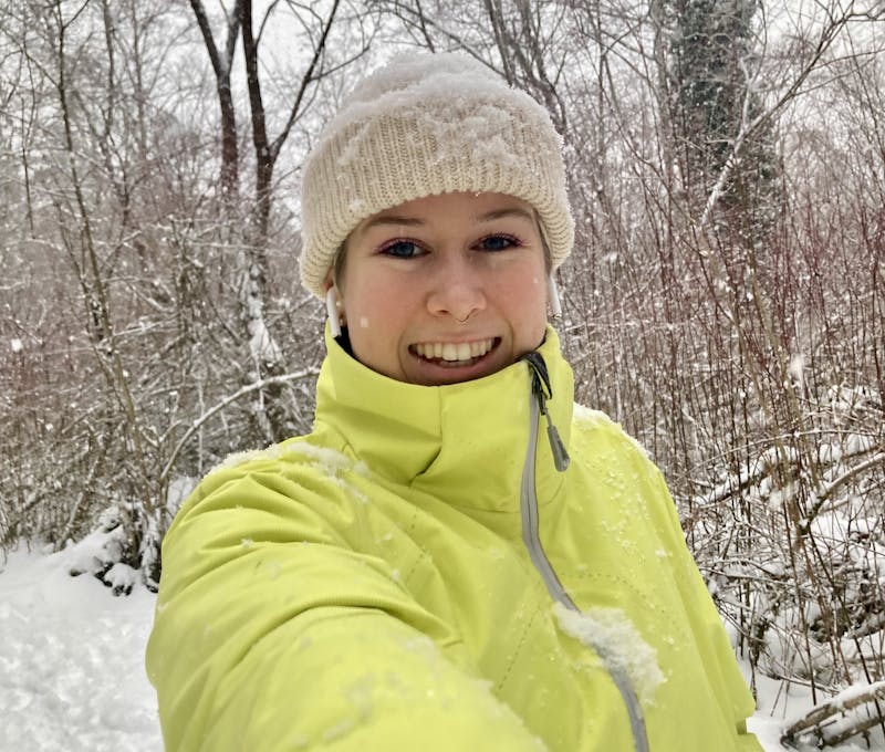 Oboz employee smiling while hiking in the snow.