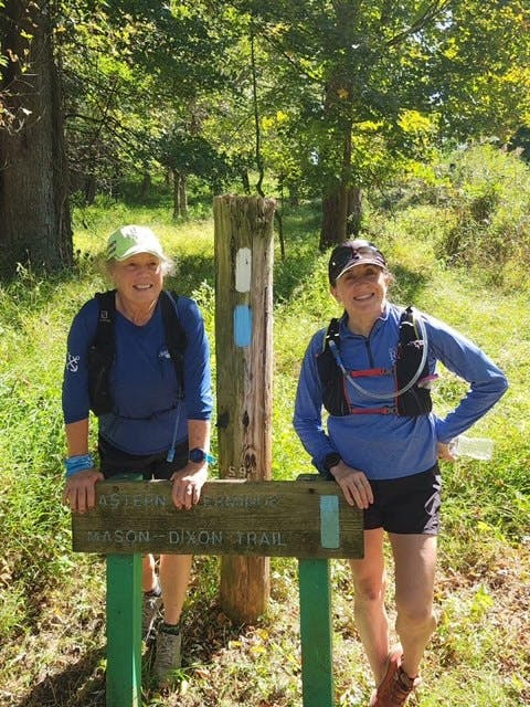 Roxanne Strine hanging with a friend on a trail run