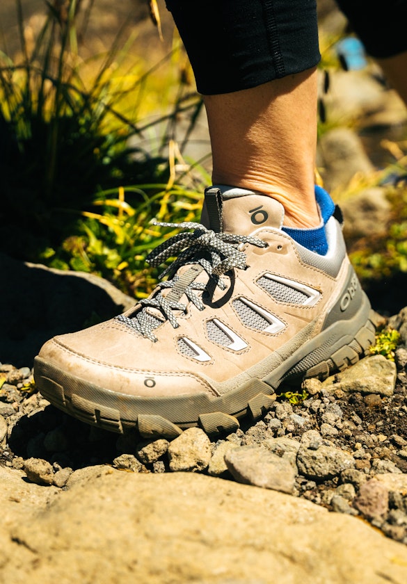 Woman hiking in Oboz Sawtooth X hiking boots through rocky trail in Patagonia.