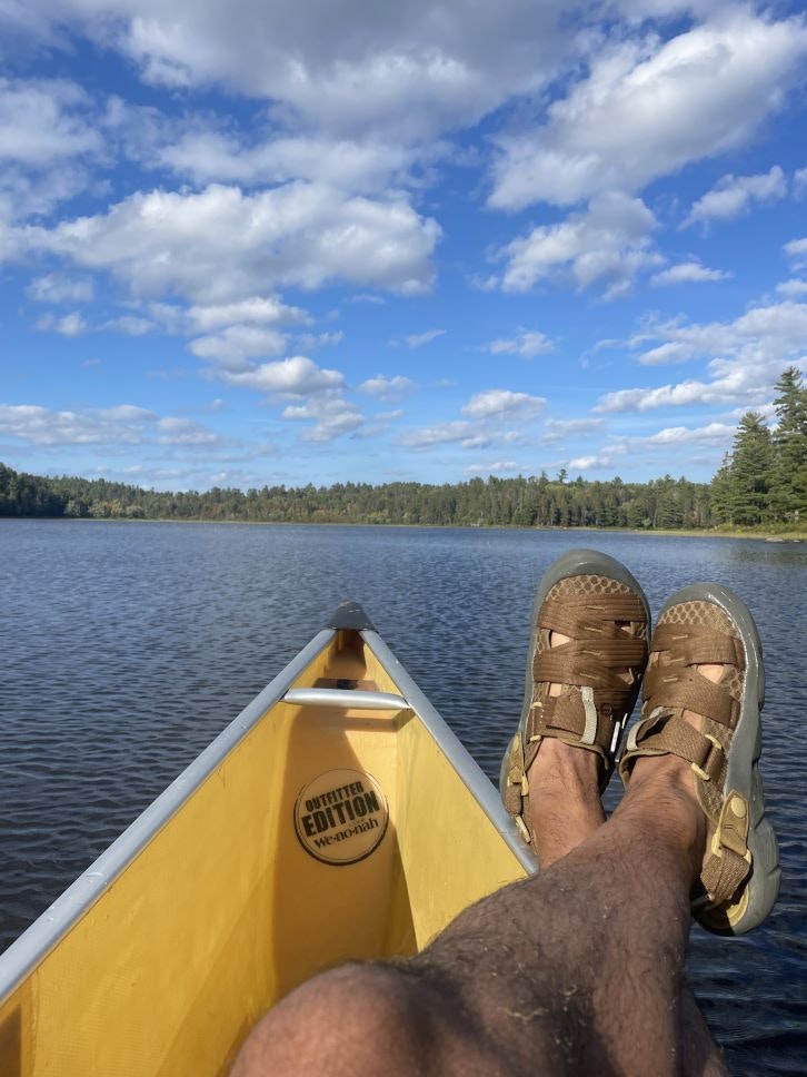 Person wearing Oboz Whakata Trail Sandals in a canoe.