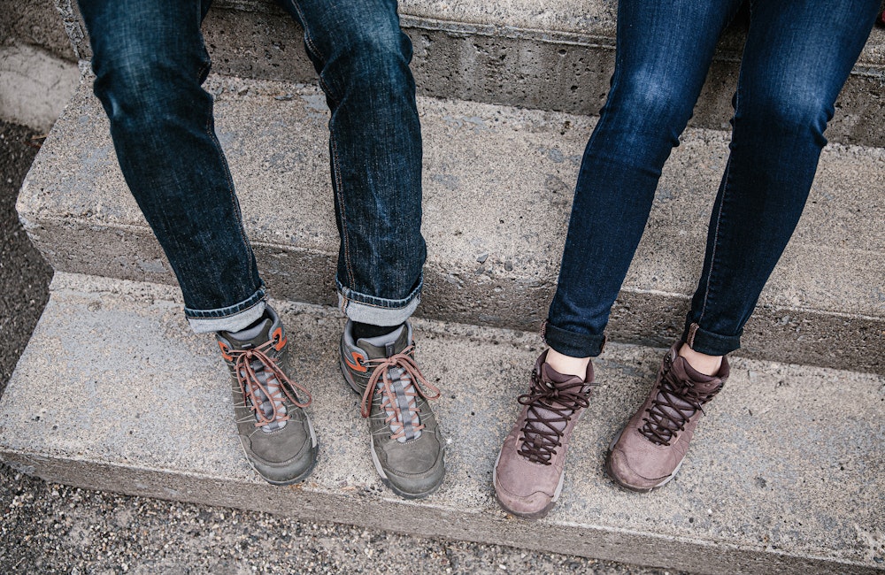 Two people wearing the Oboz Sypes Mid Leather in town.