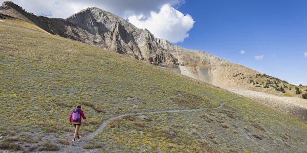 Hiker embarking on a hiking adventure in the mountains.