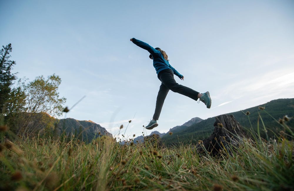 Jumping along the trail in the Hyalite Low waterproof hiker