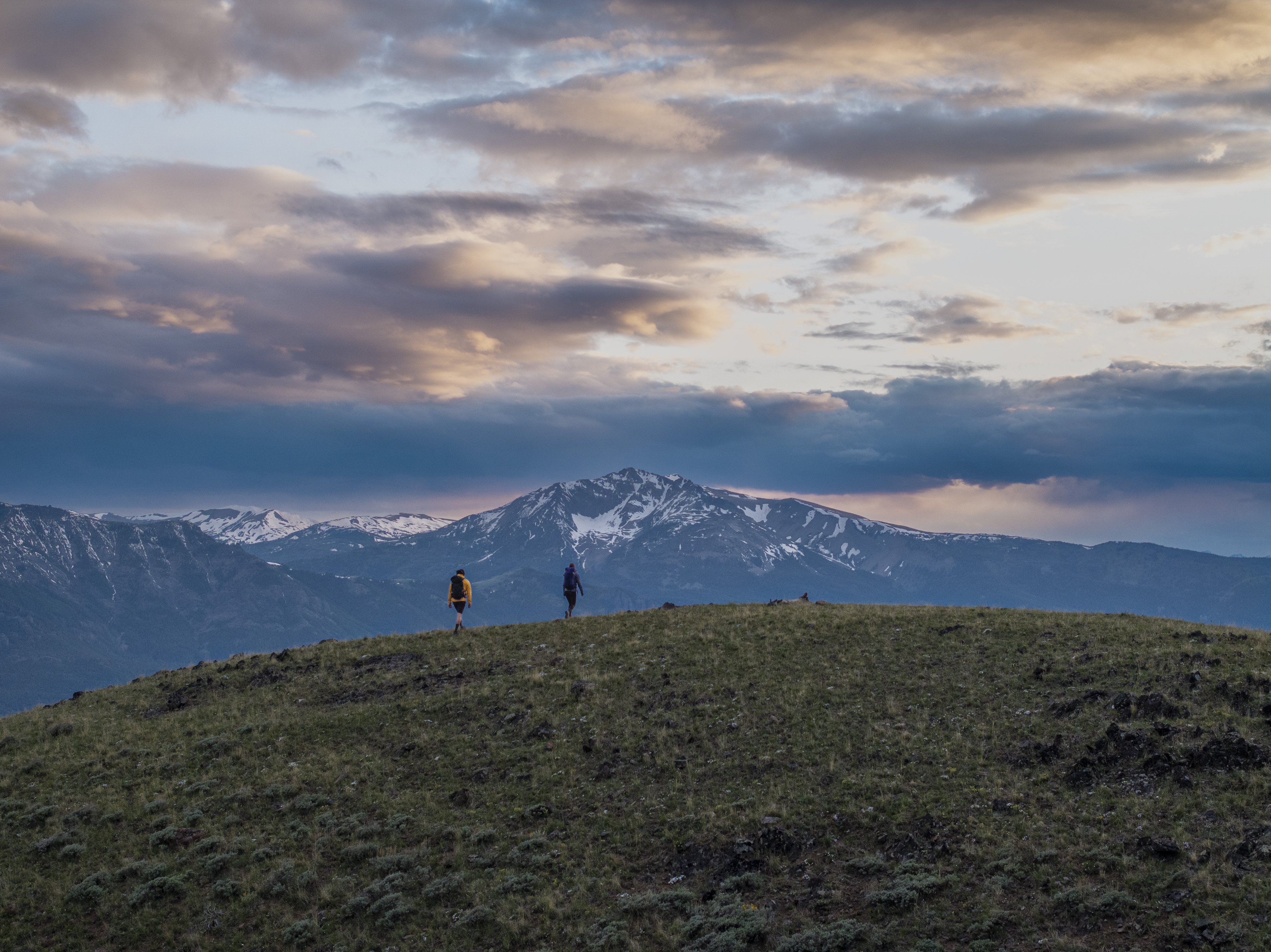 Couple hiking in the mountains at sunset