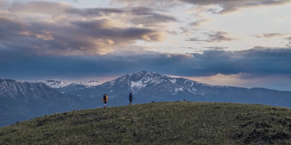 Couple hiking in the mountains at sunset